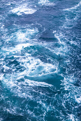 A dramatic natural scene of the Naruto Whirlpools as seen from a viewpoint near the O-naruto Bridge in Tokushima, Japan.