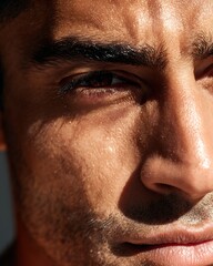 Portrait of Middle Eastern man with bold, defined eyebrows and radiant skin, no makeup.
