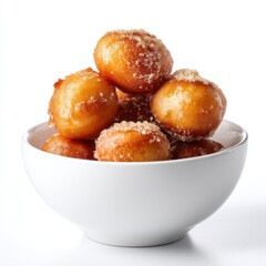 Loukoumades Greek honey doughnuts with cinnamon, stacked in a white bowl, dessert snack, isolated on white