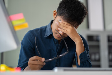stressed asian businessman working in the office. Businessman thinking too much work concept in the office.