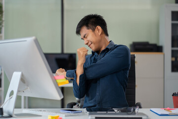 Male businessman is doing a stretchy posture due to sitting in the office for too long, office...