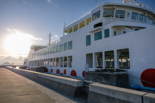 Naoshima, Japan - December 2024: ferry approaches or departs Naoshima Island in Japan Seto Inland Sea during the soft light of evening.
