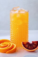 Vibrant Orange Juice Refreshment: A stunning close-up showcases a tall glass filled with chilled orange juice and ice cubes.