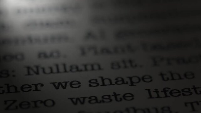 Zero waste. We shape the future. Topic of environmental conservation.  Moving text printed on a page. Headline. A piece of paper with a phrase written in retro typewriter font. Spotlight effect. 