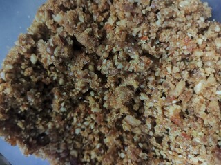  Crushed nuts and grains shown in a detailed food surface texture.