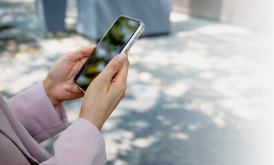 Businesswoman's hands using smartphone to chat with friends via messaging app. Social network concept.