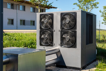 Commercial air source heat pump system installed outdoors. These systems are common in...