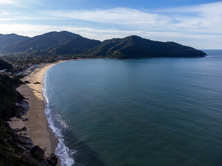 Beautiful coastal village with beautiful green water beach and tropical mountains around