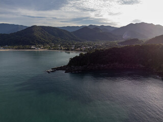 Beautiful coastal village with beautiful green water beach and tropical mountains around