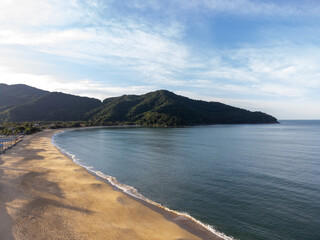 Beautiful beach with orange sands and greenish waters without people in the morning