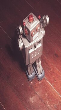 Retro dancing robot on a wooden floor 