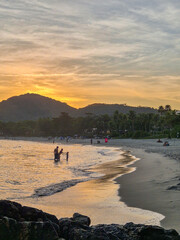 amazing red sunset among the rocks on a tropical beach