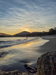 amazing red sunset among the rocks on a tropical beach