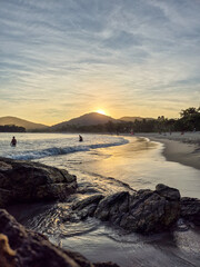 amazing red sunset among the rocks on a tropical beach