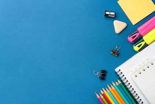 Bright school supplies on a blue background. The back to school concept