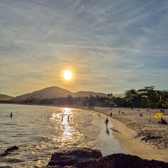 amazing red sunset among the rocks on a tropical beach