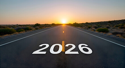 A long, empty road stretches into the horizon under a vibrant sunset. The year 2026 is prominently displayed on the asphalt, symbolizing future journeys and possibilities	