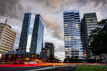 Modern High-Rise Buildings in Ljubljana With Reflections and Light Trails Under a Dramatic Sunset...