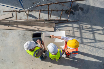 Three Asian engineer working at site of a large building project,Work overtime at construction...