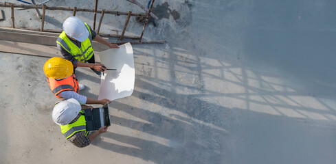 Three Asian engineer working at site of a large building project,Work overtime at construction...