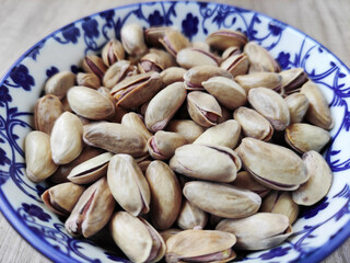 Fresh natural dried pistachios in a decorative plate