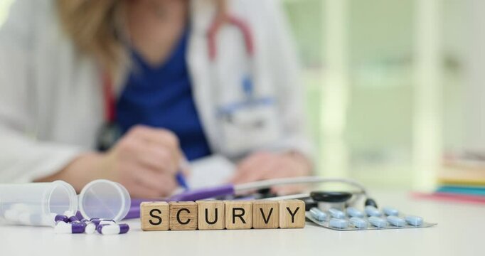Healthcare professional documents Scurvy diagnosis shown on cubes near pills and stethoscope on desk. Importance of vitamin C deficiency treatment