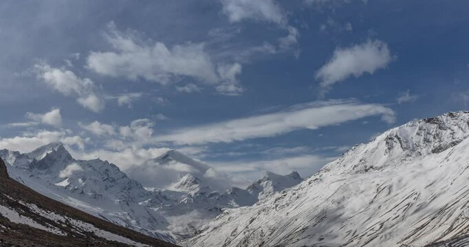 4K timelapse video of clouds drifting over snow-covered Nun Kun mountains in Zanskar Valley, Ladakh, India