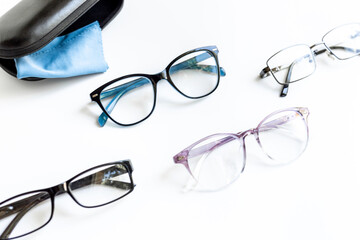 Many different styles of eyeglasses with lenses on white. Eye care and protection concept