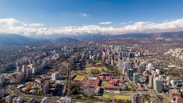 A cinematic aerial hyperlapse of Santiago, Chile, captured after rainfall, showing the skyline of the city with the Andes Mountains behind. Ideal for travel, urban, or editorial content.