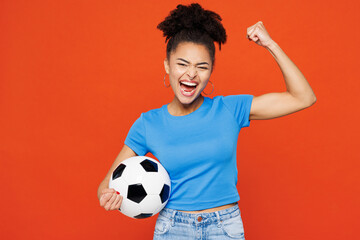 Young woman fan wear blue t-shirt cheer up support football sport team hold in hand soccer ball...