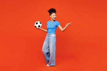 Full body young woman fan wear blue t-shirt cheer up support football sport team hold soccer ball...