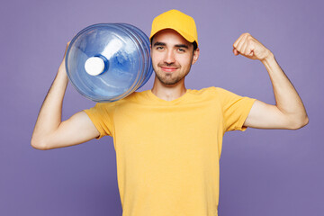 Young strong delivery guy employee man wear yellow cap t-shirt uniform workwear work as dealer...