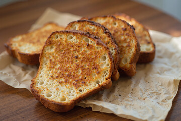 Golden-brown slices of toasted bread, perfectly crisp and inviting. A simple yet delicious snack or addition to any meal.