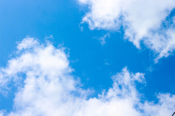 Bright Blue Sky with Soft White Clouds on a Clear Sunny Day – Peaceful Natural Background for Weather, Travel, and Outdoor Concepts