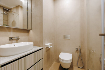 A functional bathroom that includes a toilet, sink, and shower area