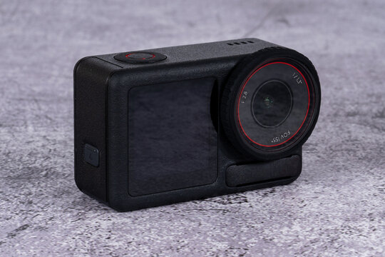black action camera front view placed on the table - Powered by Adobe