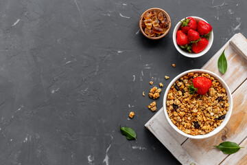 Bowl with oatmeal granola and ingredients. Top view