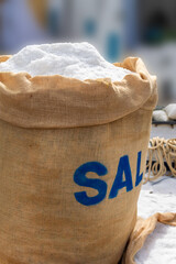 Close-up og a large jute sack filled with coarse sea salt at a market