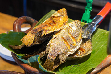 Assorted Side Dishes, Indonesia, captured on May 29, 2025. A variety of traditional Indonesian foods including tempeh, tofu, chicken, eggs, and vegetables served with sambal