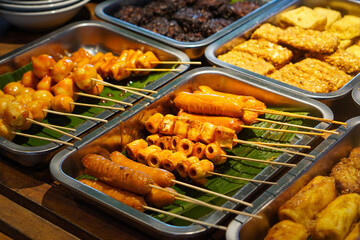 Assorted Satay, Indonesia, captured on May 29, 2025. A traditional Indonesian dish featuring skewered and grilled meat varieties served with spicy peanut sauce, soy glaze, and fresh side dishes