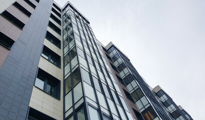 Residential apartment building from top to bottom. Commercial real estate, building. Buying, renting real estate. City apartments.