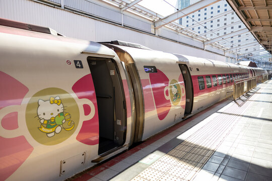 Japan - December 2024: Hello Kitty Shinkansen, a themed bullet train operated by JR West, stands at the platform in Japan. Decorated with pink accents and Hello Kitty designs both inside and outside.