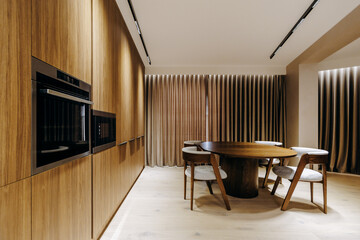 A cozy dining room with a wooden table, matching chairs, and curtains