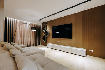 A cozy living room with a comfy couch and a wallmounted TV