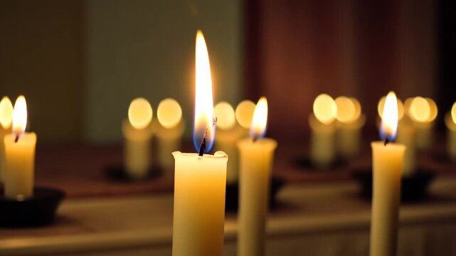 Close Up of Lit Candles in Dark Setting