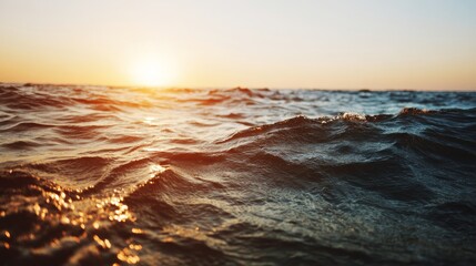 Obraz premium Tranquil ocean view with calm waves under golden sunset, minimalist seascape with copy space, conveying peace, relaxation and freedom of coastal life.