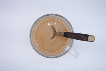 Coffee with condensed milk, ready to eat in a clear glass cup.