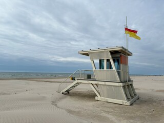 miami beach lifeguard tower, Modern lifeguard tower on a wide sandy beach by the sea under a cloudy...