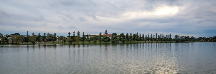 Serene Panoramic Lakeside Scene with Trees and Reflection Under Cloudy Sky at Lake Monger, Perth, Australia, 24 April 2020