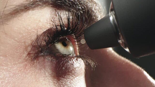 A woman measures her eye pressure with a modern portable tonometer in close-up. Concept of ophthalmologic diagnosis and treatment.